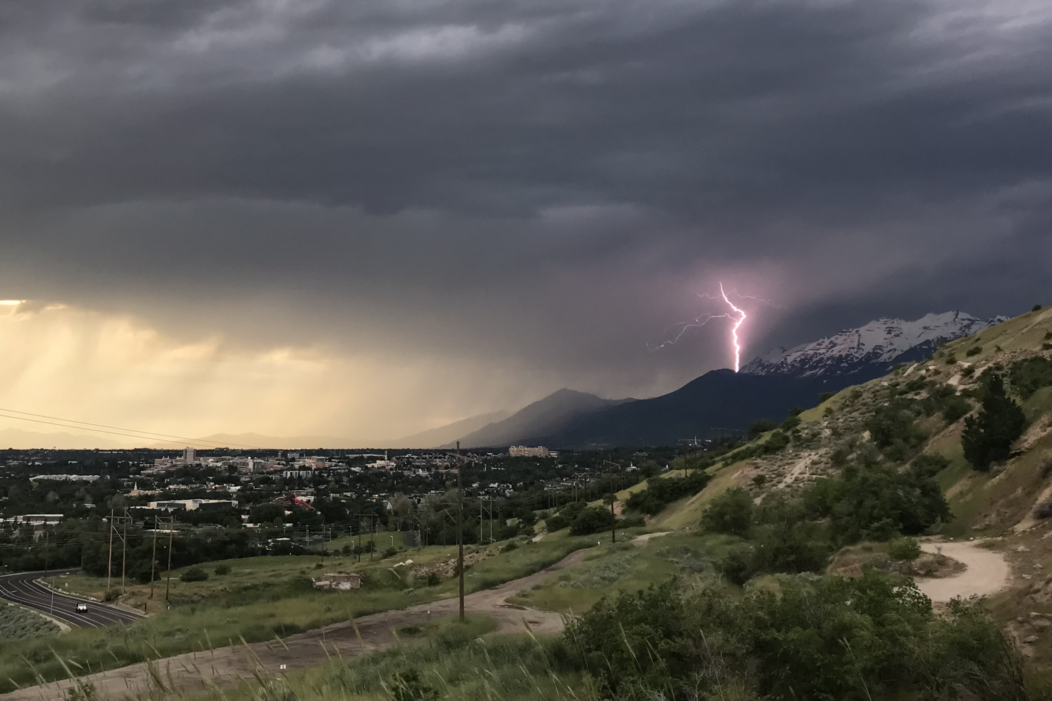 purple lightning strikes timpanogus mountain in the distance